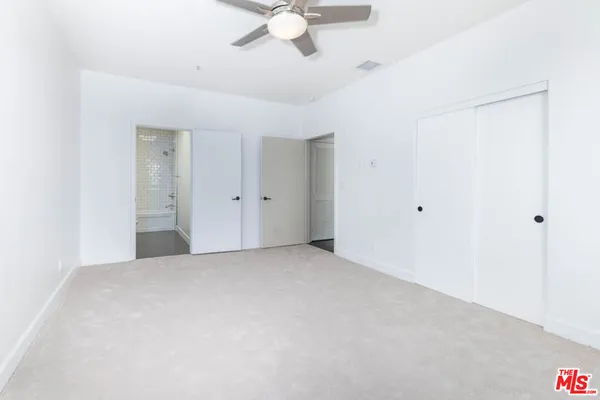 a view of a livingroom with a ceiling fan and window