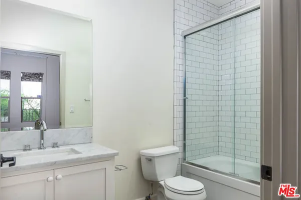 a bathroom with a toilet a sink and shower