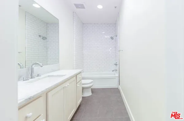 a bathroom with a double vanity sink toilet and shower