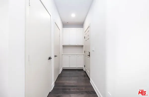 a view of a hallway with wooden floor