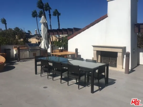 a view of a dinning table and chairs in the patio