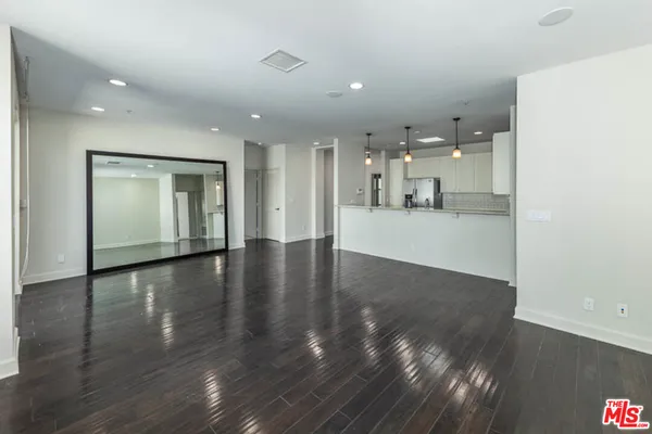 a view of a kitchen with a sink and wooden floor