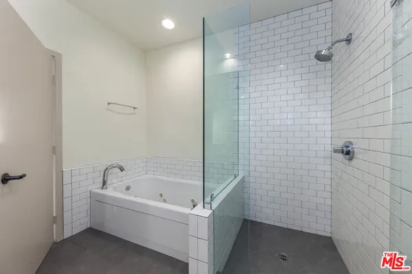 a bathroom with a bathtub and shower