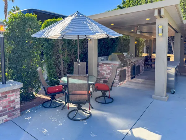 a view of a patio with table and chairs potted plants with wooden floor