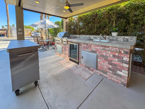 a view of a patio with a table and chairs