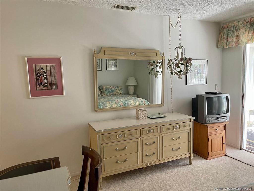 2600 Southeast Ocean Boulevard, Unit H9 Stuart, FL 34996 - Photo 14 of 21 a bathroom with a granite countertop sink a mirror a vanity and a shower