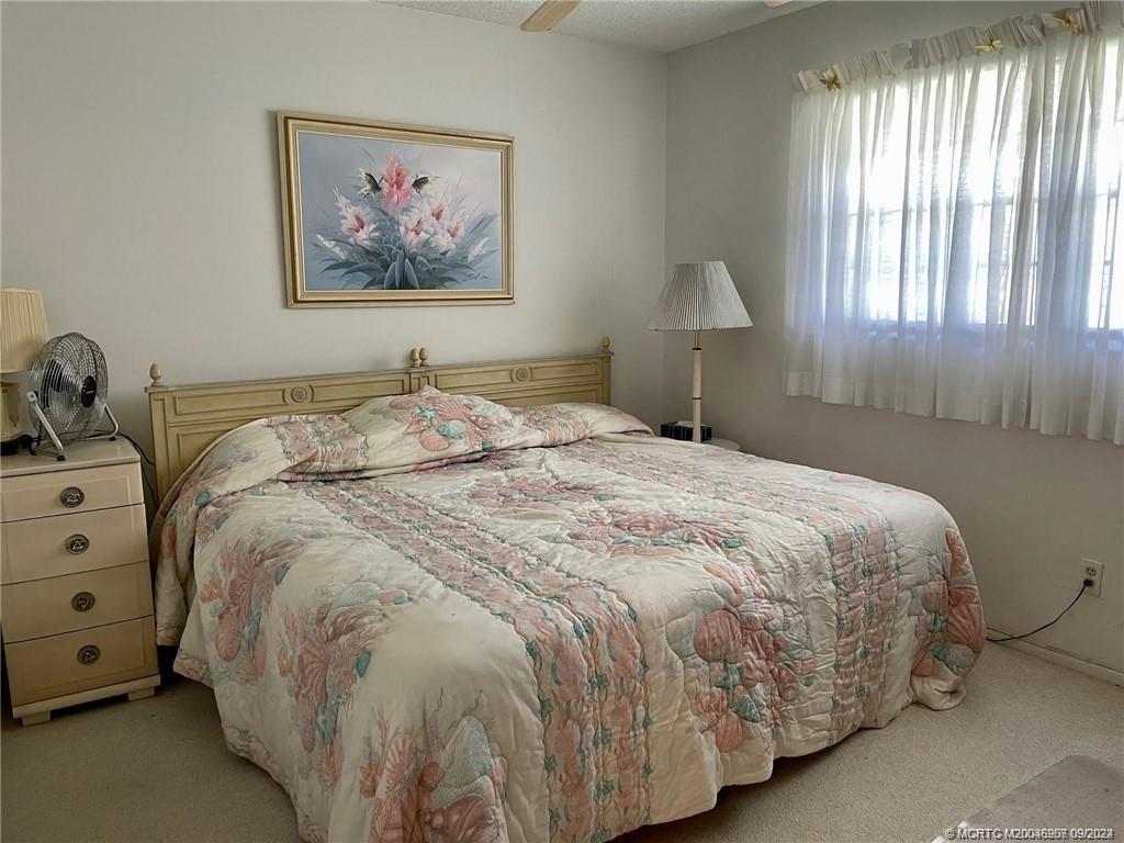 2600 Southeast Ocean Boulevard, Unit H9 Stuart, FL 34996 - Photo 15 of 21 a bed sitting in a bedroom next to a window