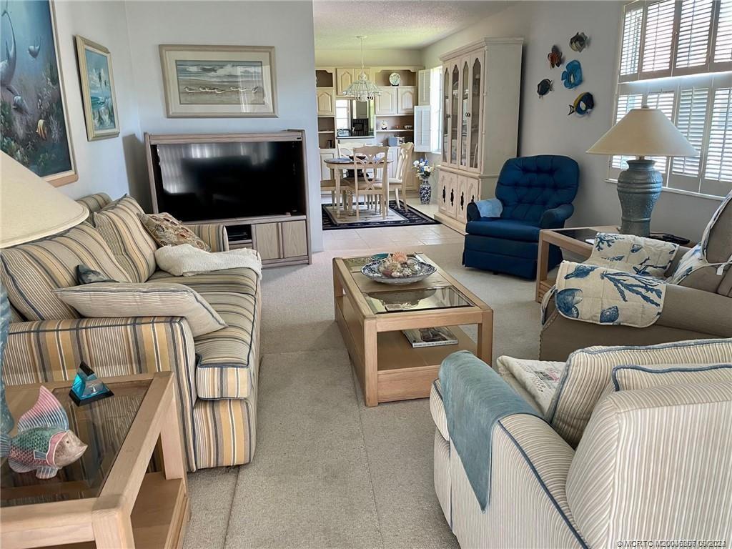 2600 Southeast Ocean Boulevard, Unit H9 Stuart, FL 34996 - Photo 8 of 21 a living room with furniture and a flat screen tv