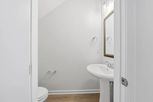 a bathroom with a sink toilet and mirror