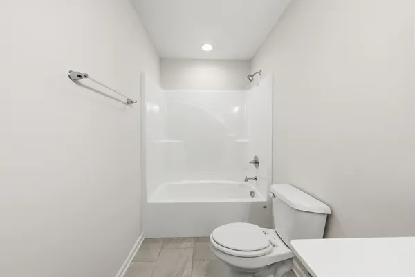 a bathroom with a toilet and a bath tub