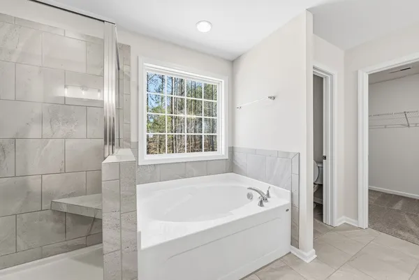 a white bath tub sitting next to a window