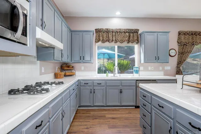 a kitchen with a stove a sink and a refrigerator