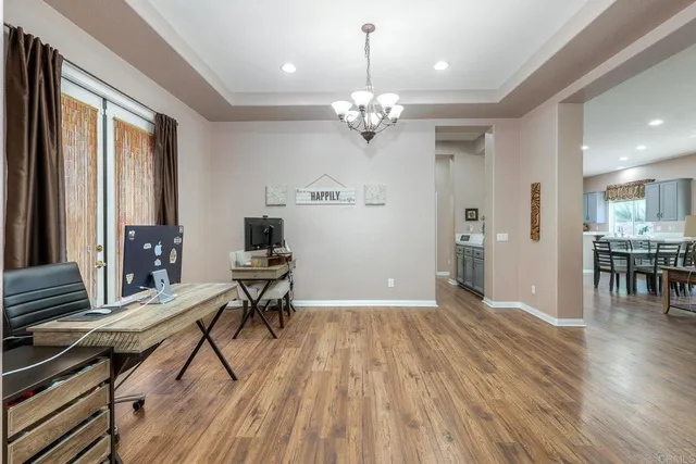 a spacious bedroom with a bed and wooden floor