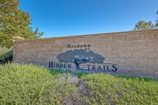a view of a patio with table and chairs under an umbrella