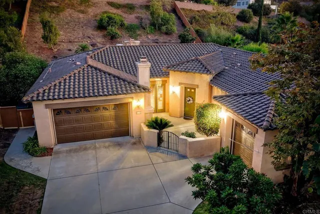 a aerial view of a house with table and chairs and a fire pit