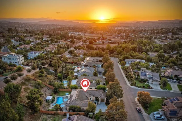 an aerial view of a house with garden space and patio