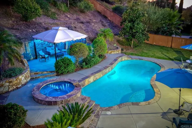 an aerial view of a house with yard and outdoor seating