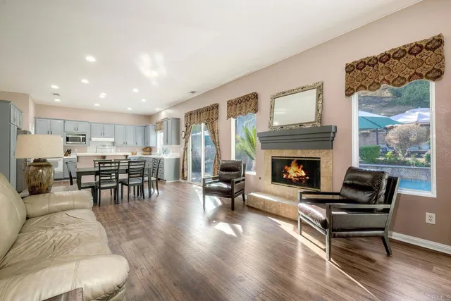 a living room with furniture a table and wooden floor