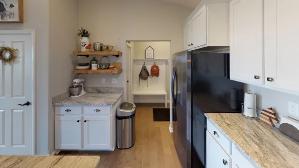 a kitchen with stainless steel appliances granite countertop a refrigerator and a sink