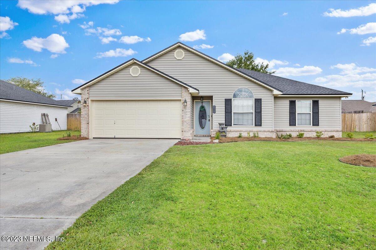 a front view of house with yard and green space