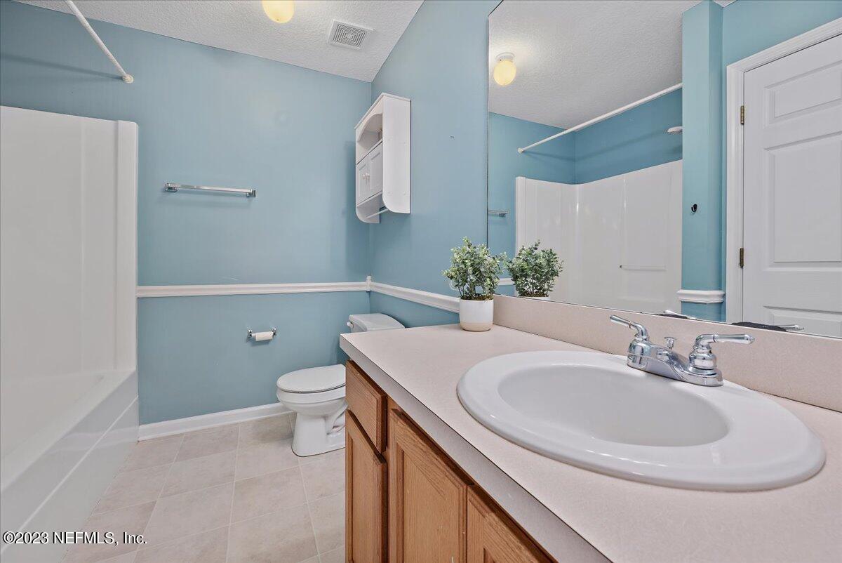 681 Fox Run Circle Macclenny, FL 32063 - Photo 12 of 18 a bathroom with a sink a toilet and mirror