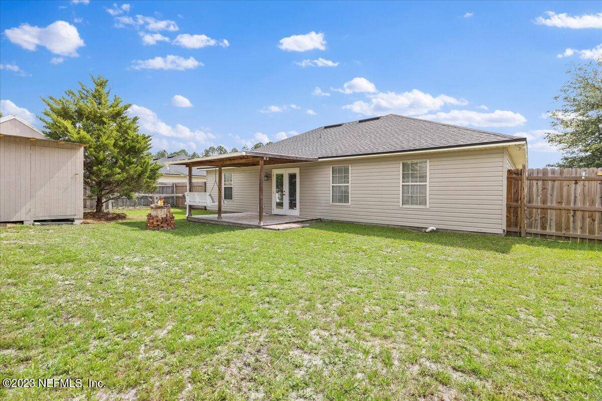 681 Fox Run Circle Macclenny, FL 32063 - Photo 13 of 18 a view of a house with a backyard