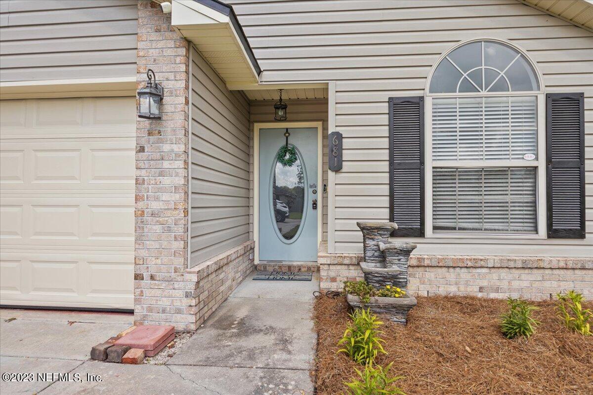 681 Fox Run Circle Macclenny, FL 32063 - Photo 2 of 18 a front view of a house with outdoor seating