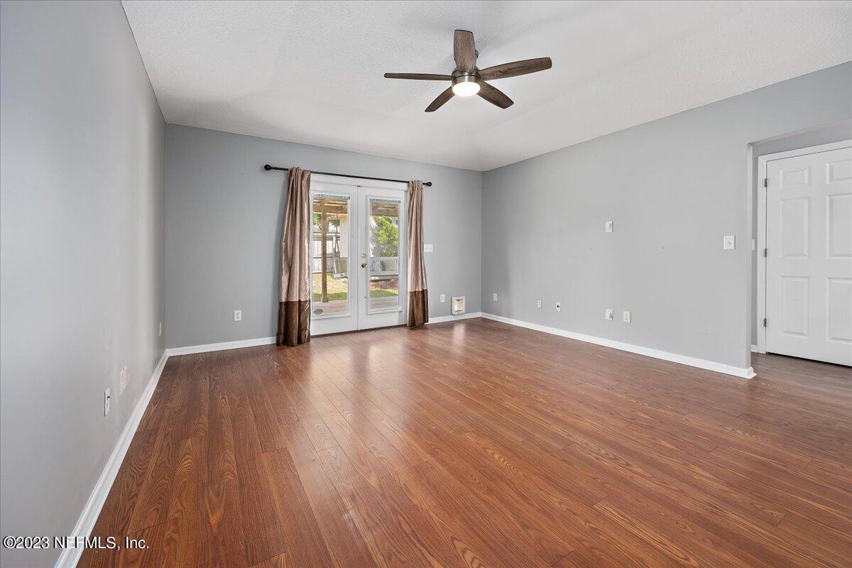681 Fox Run Circle Macclenny, FL 32063 - Photo 3 of 18 a view of empty room with wooden floor and fan