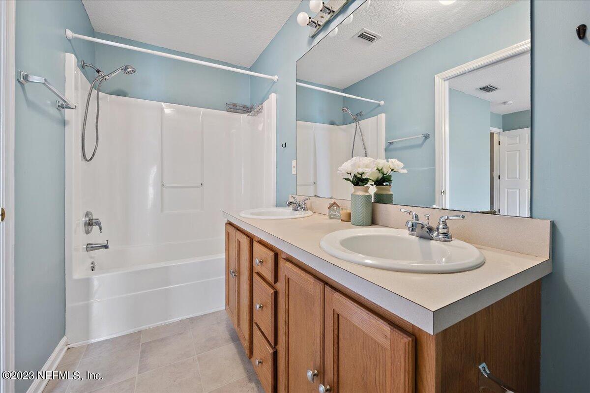 681 Fox Run Circle Macclenny, FL 32063 - Photo 8 of 18 a bathroom with a granite countertop sink and a mirror