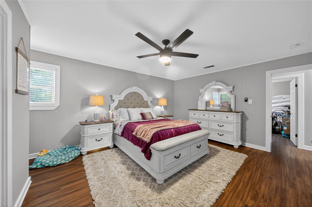 614 Colonial Drive Athens, TX 75751 - Photo 15 of 26 a spacious bedroom with a bed and a dresser with wooden floor