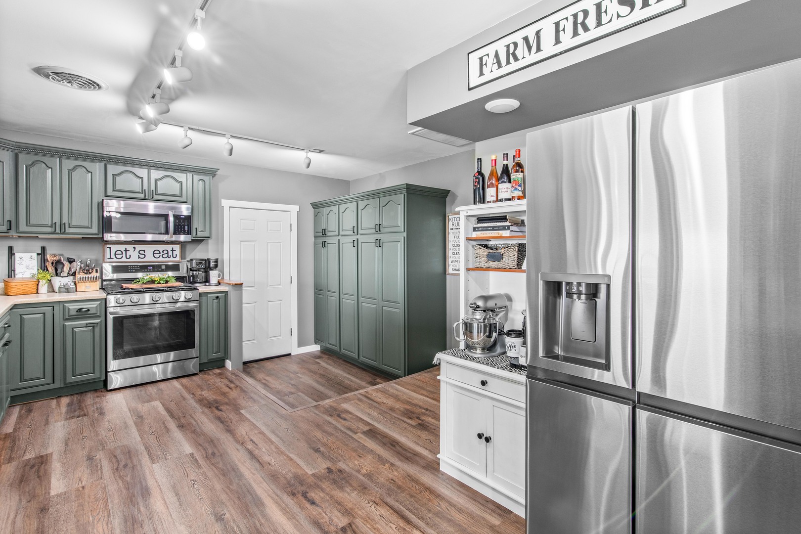 4698 East 17th Road Leland, IL 60531 - Photo 11 of 57 a kitchen with stainless steel appliances a stove refrigerator and cabinets