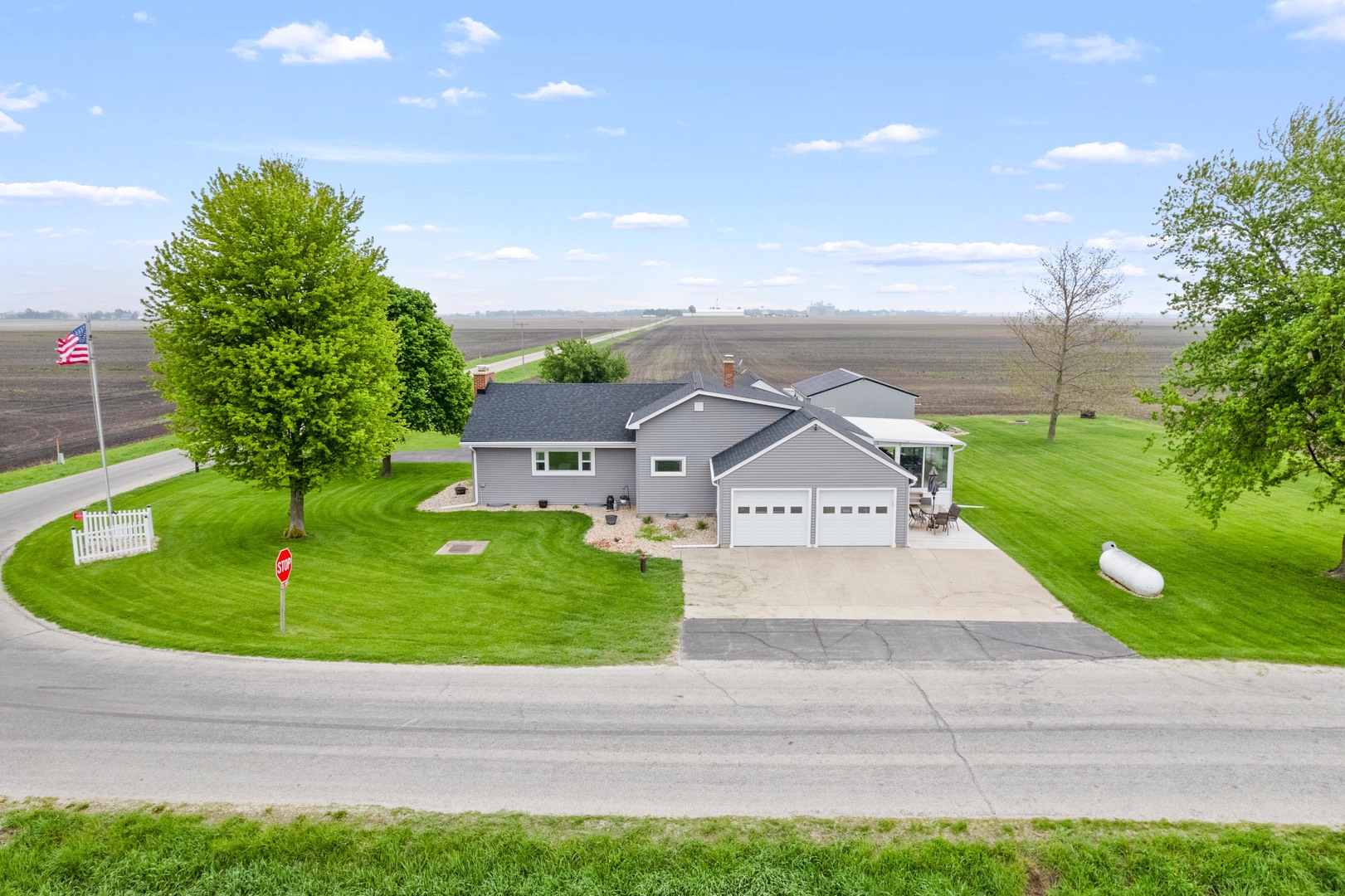 4698 East 17th Road Leland, IL 60531 - Photo 41 of 57 a view of a house with a yard and a garage