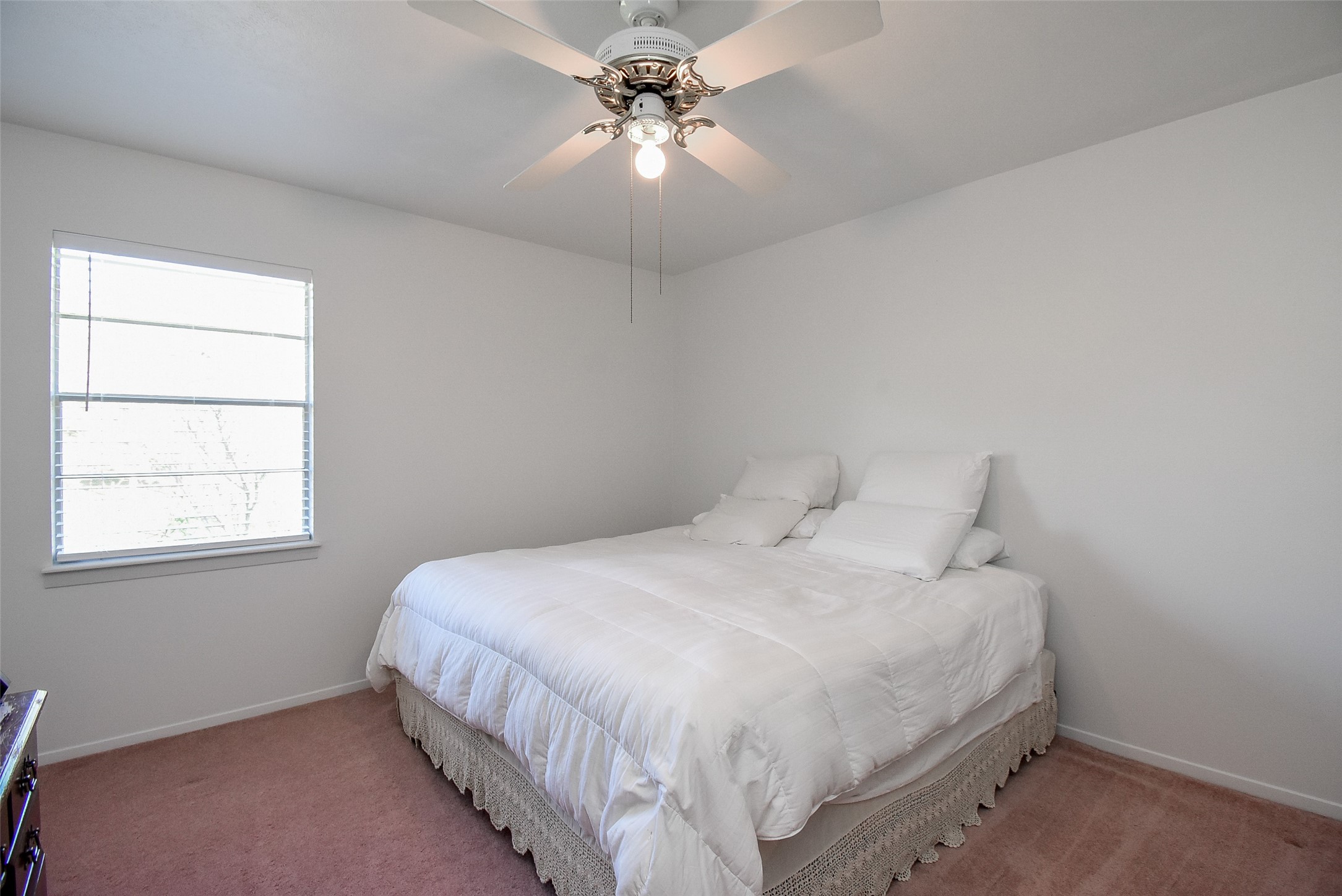 24640 Macedonia Road Hockley, TX 77447 - Photo 26 of 46 a bedroom with a bed and a chandelier fan