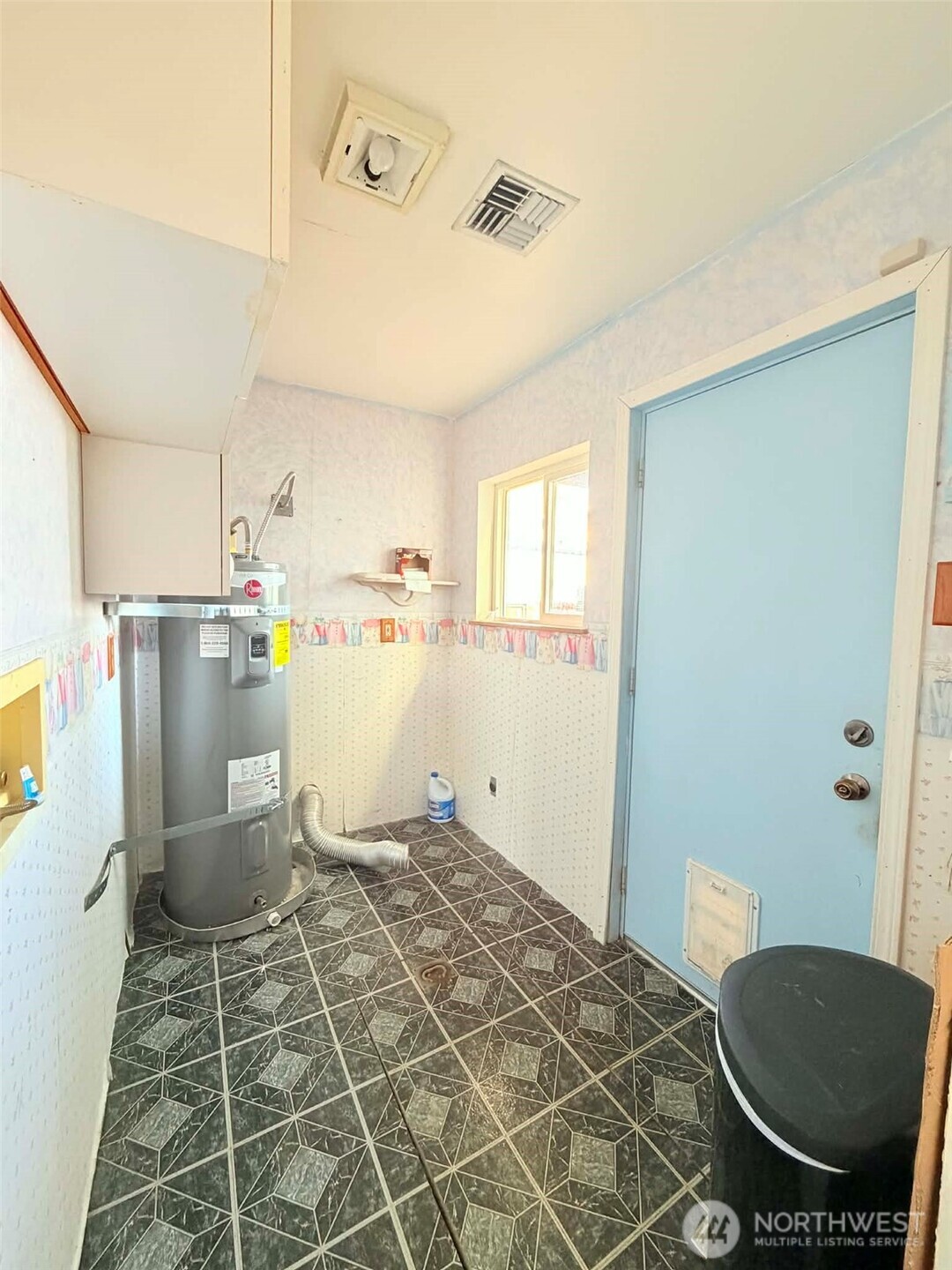 2006 West Second Street Aberdeen, WA 98520 - Photo 37 of 39 a room with a washing machine and wooden floor