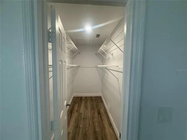 a bathroom with a sink a toilet a shower and a window