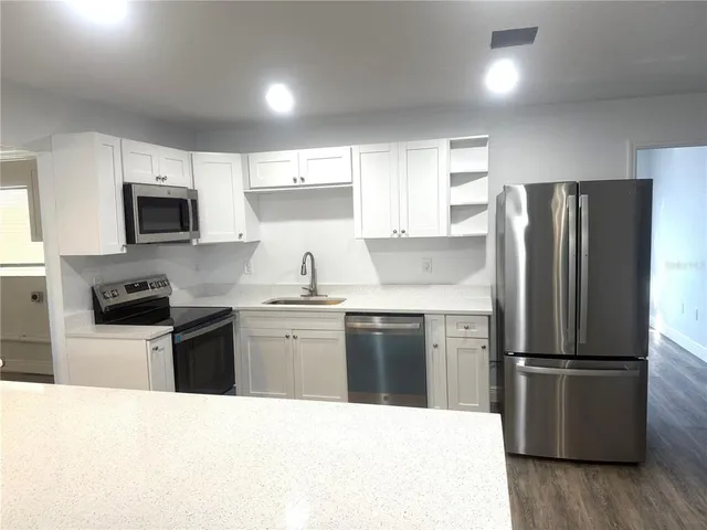 a kitchen with a refrigerator stove and microwave