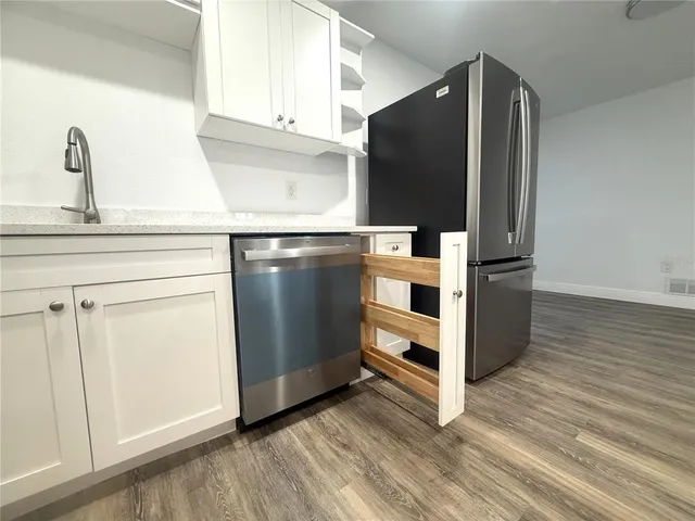 a kitchen with stainless steel appliances a refrigerator and cabinets