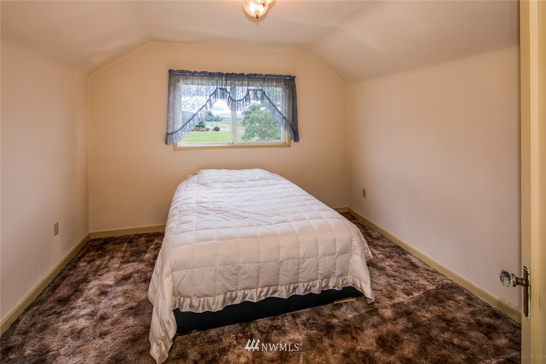 7332 Nooksack Road Everson, WA 98247 - Photo 13 of 33 a bed sitting in a bedroom next to a window