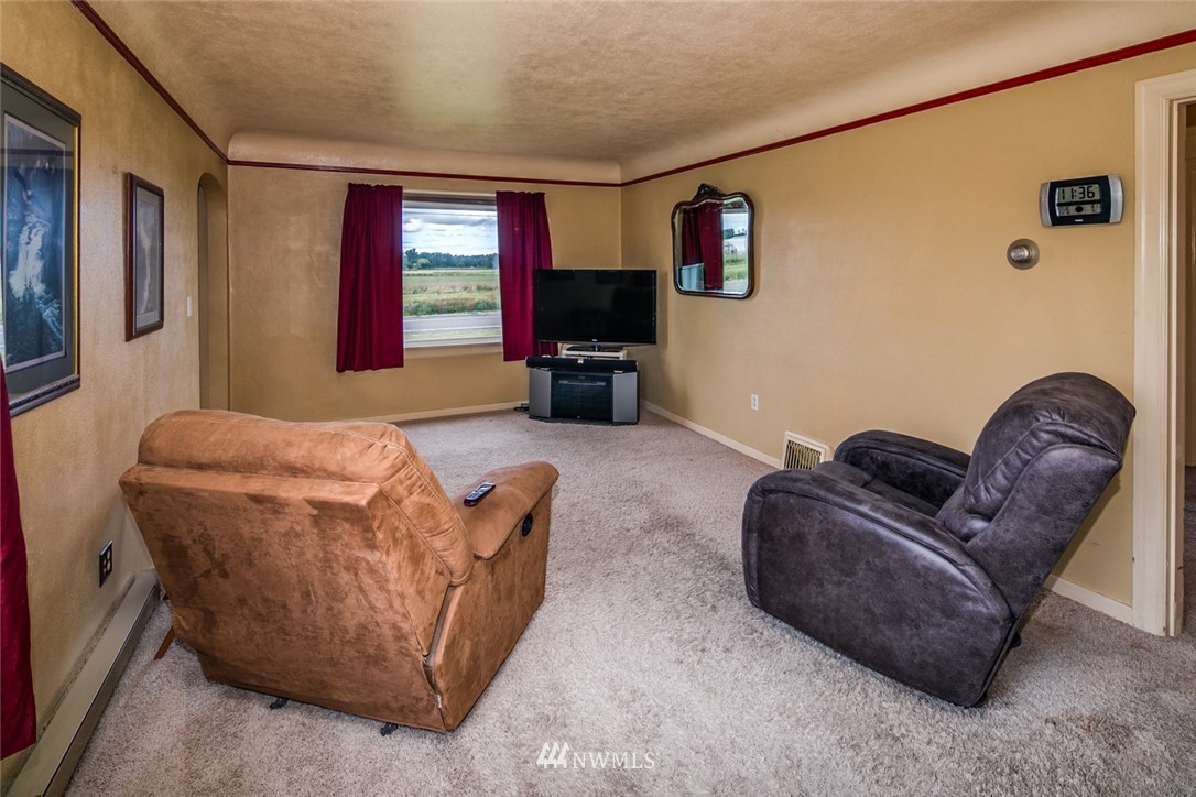 7332 Nooksack Road Everson, WA 98247 - Photo 4 of 33 a living room with furniture a flat screen tv and a fireplace