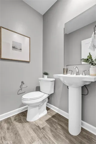 a bathroom with a sink toilet and a mirror