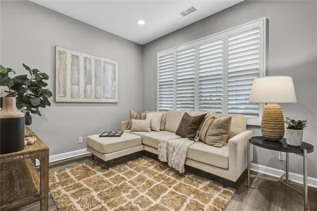 a living room with furniture and a lamp