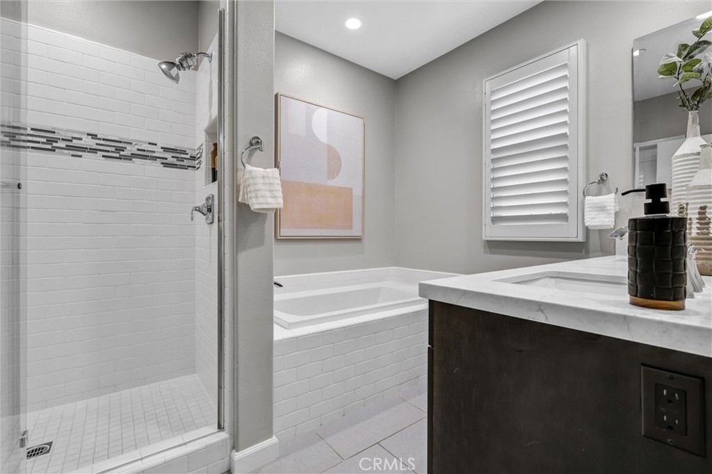 107 Copeland Irvine, CA 92618 - Photo 22 of 30 a bathroom with a granite countertop sink and a bathtub