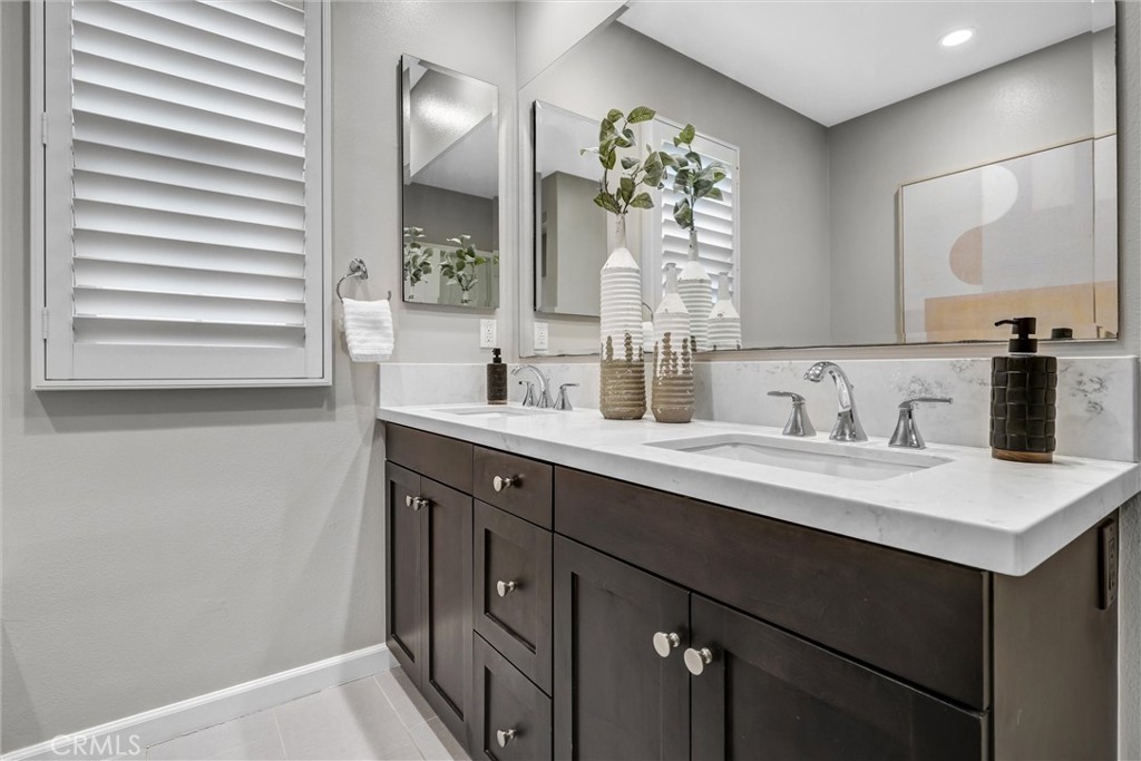 107 Copeland Irvine, CA 92618 - Photo 23 of 30 a bathroom with a double vanity sink and a mirror