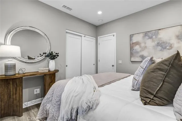 a bedroom with a bed and a mirror