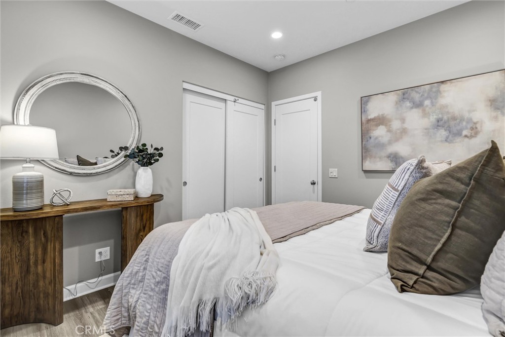 107 Copeland Irvine, CA 92618 - Photo 26 of 30 a bedroom with a bed and a mirror