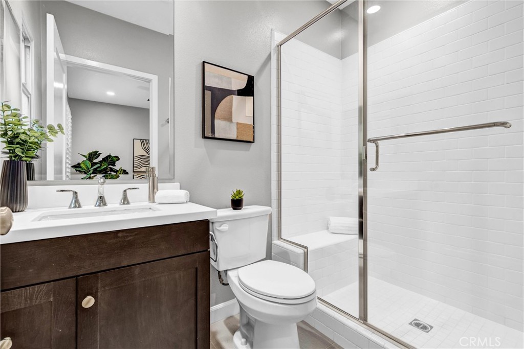 107 Copeland Irvine, CA 92618 - Photo 5 of 30 a bathroom with a sink toilet a mirror and shower