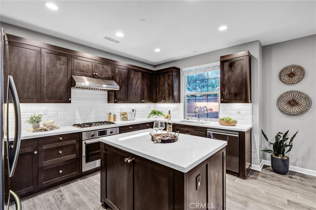 107 Copeland Irvine, CA 92618 - Photo 6 of 30 a kitchen with a sink a stove and cabinets