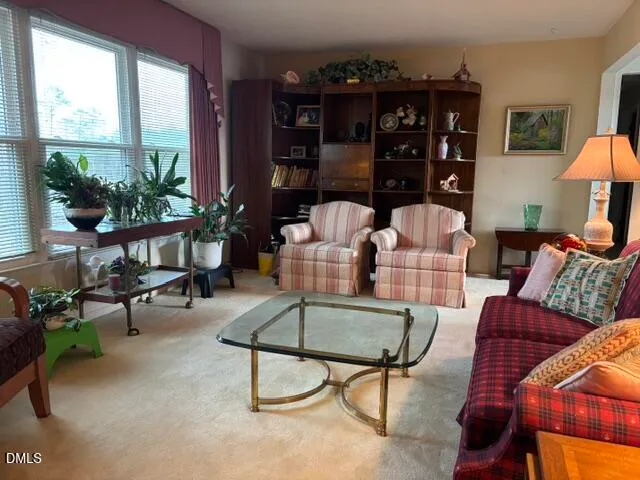 a living room with furniture and a floor to ceiling window