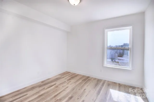 a kitchen with granite countertop white cabinets white appliances and a sink