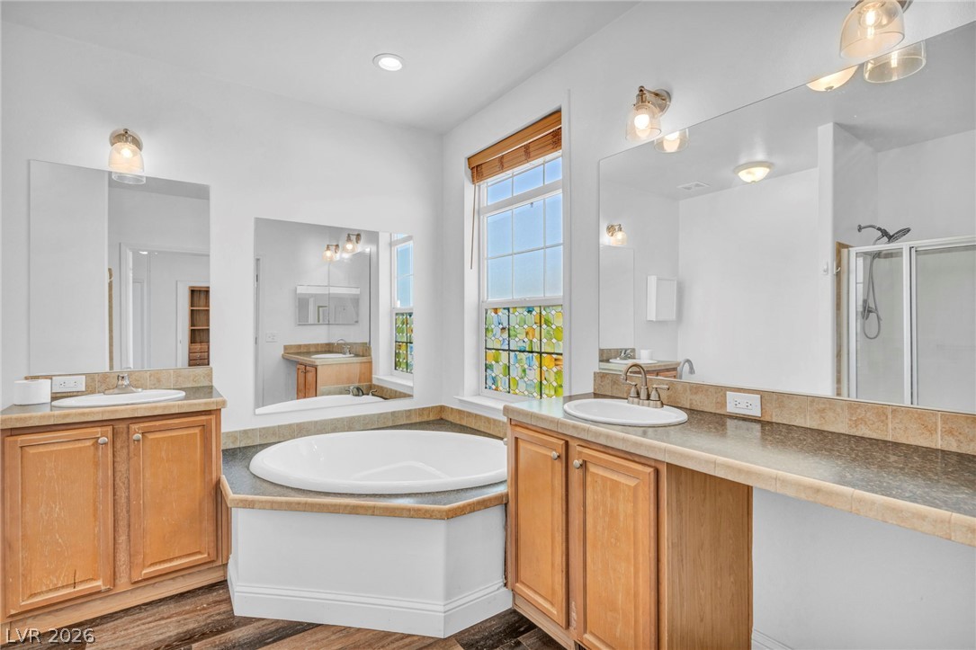 225 California Street Searchlight, NV 89046 - Photo 40 of 64 Indulge in a tranquil retreat with a deep soaking tub and dual vanities, perfect for unwinding.